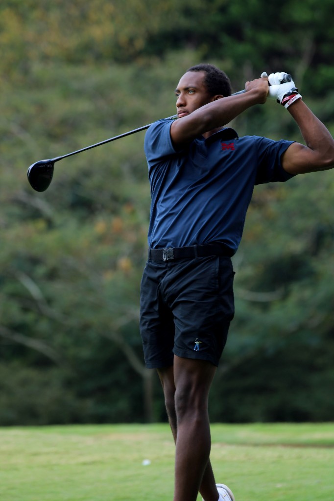 A golfer following through on a drive