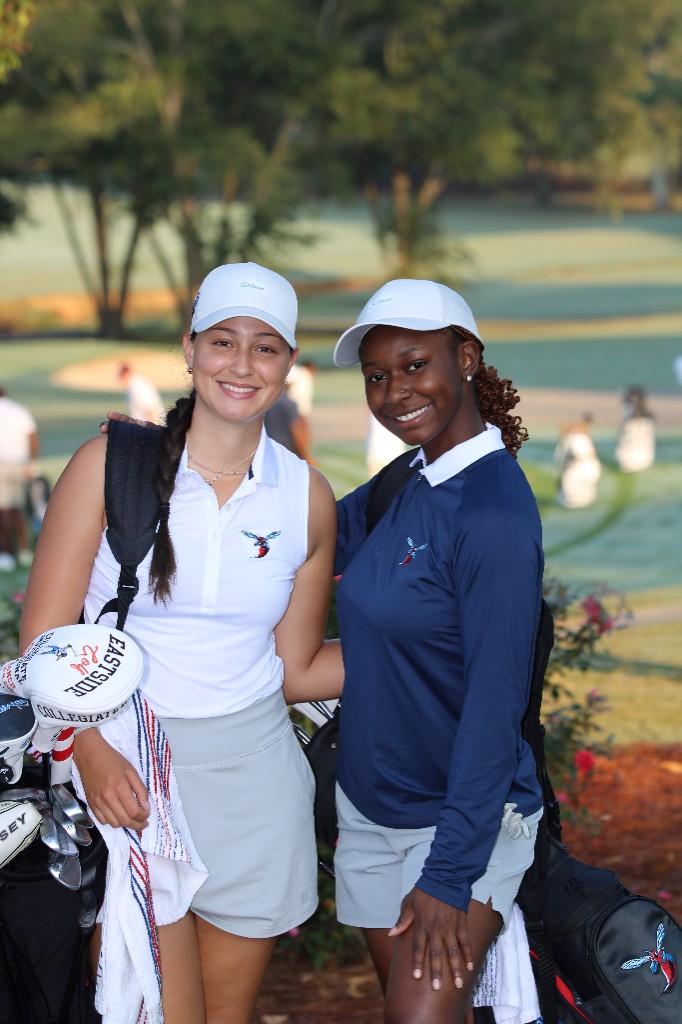 Two HBCU golfers smiling on the course
