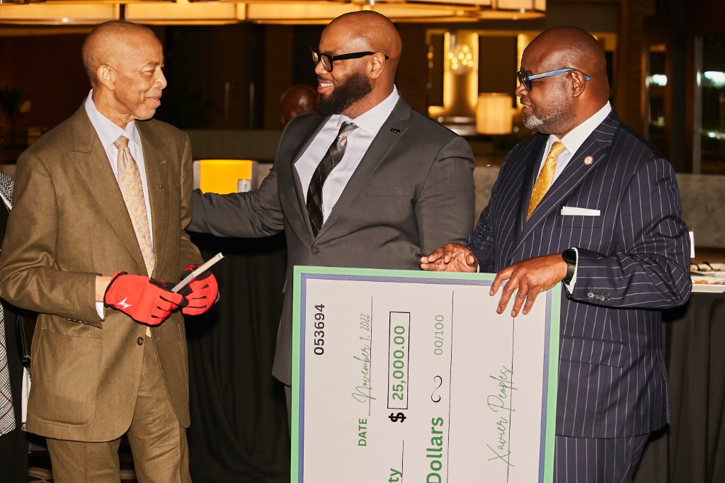 A ceremonial check presentation at a Foundation event