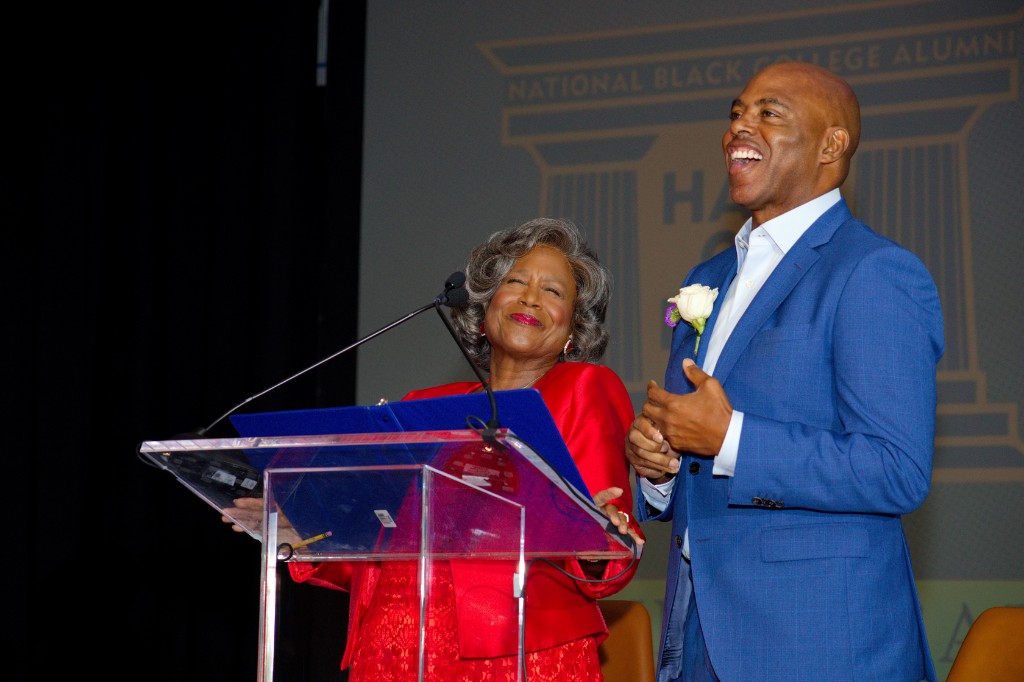 Speakers laughing on stage at Hall of Fame Weekend