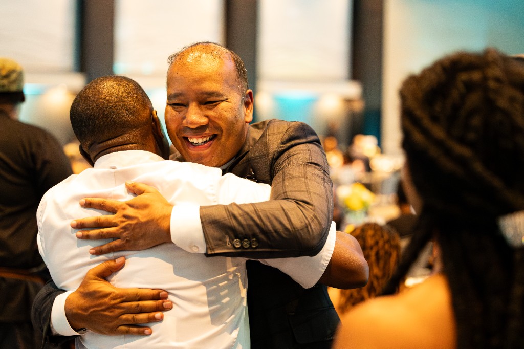 Two guests embracing at Hall of Fame Weekend